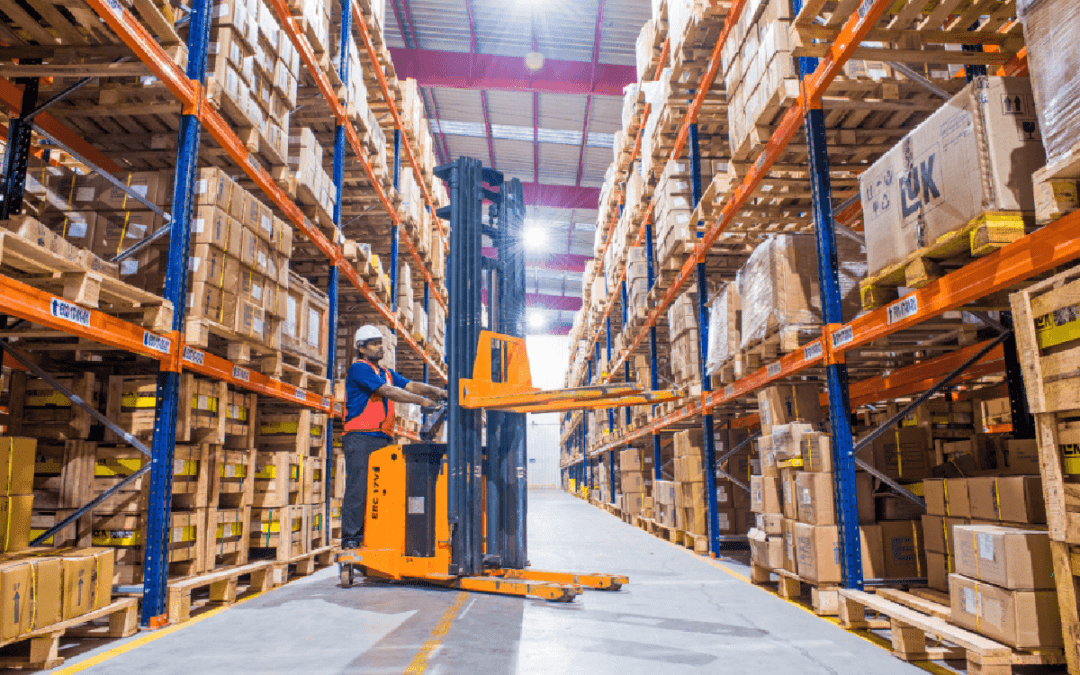 Warehouse worker scanning inventory on storage racking