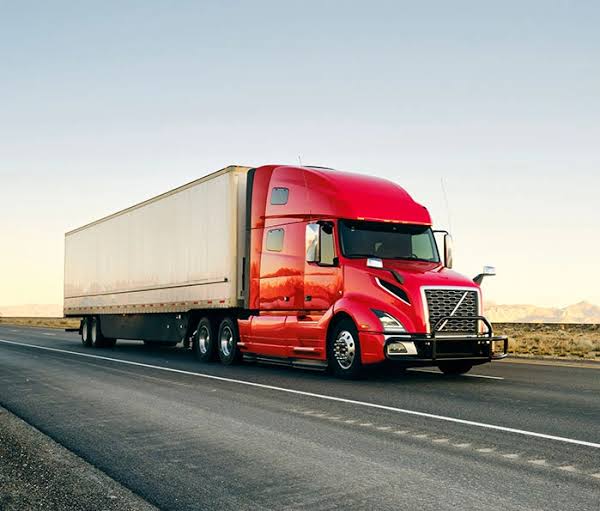 Land transport freight truck driving on a highway